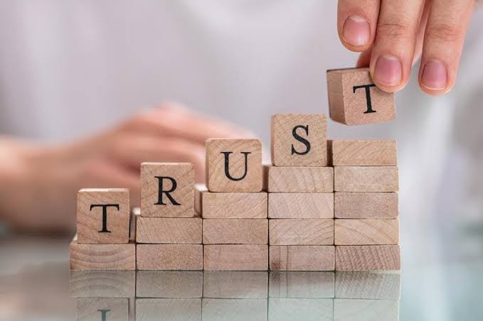 Trust spelled out with toy blocks, highlighting relationship strength and financial honesty.