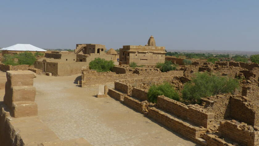 Stone ruins of the abandoned Kuldhara village near Jaisalmer, lying silent in the desert for over 200 years.