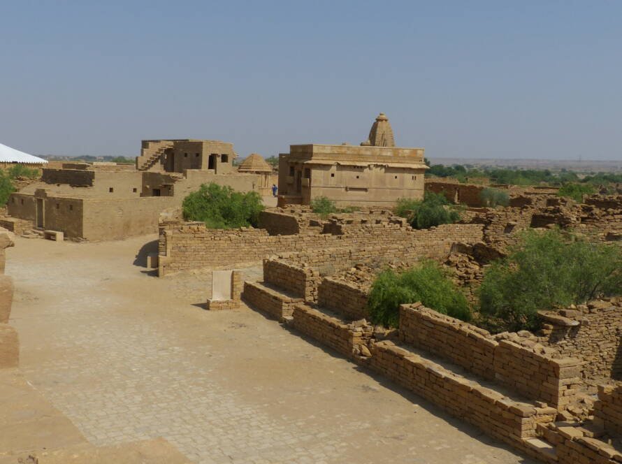 Stone ruins of the abandoned Kuldhara village near Jaisalmer, lying silent in the desert for over 200 years.